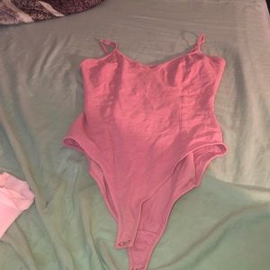 All pink tight criss cross back bodysuit
